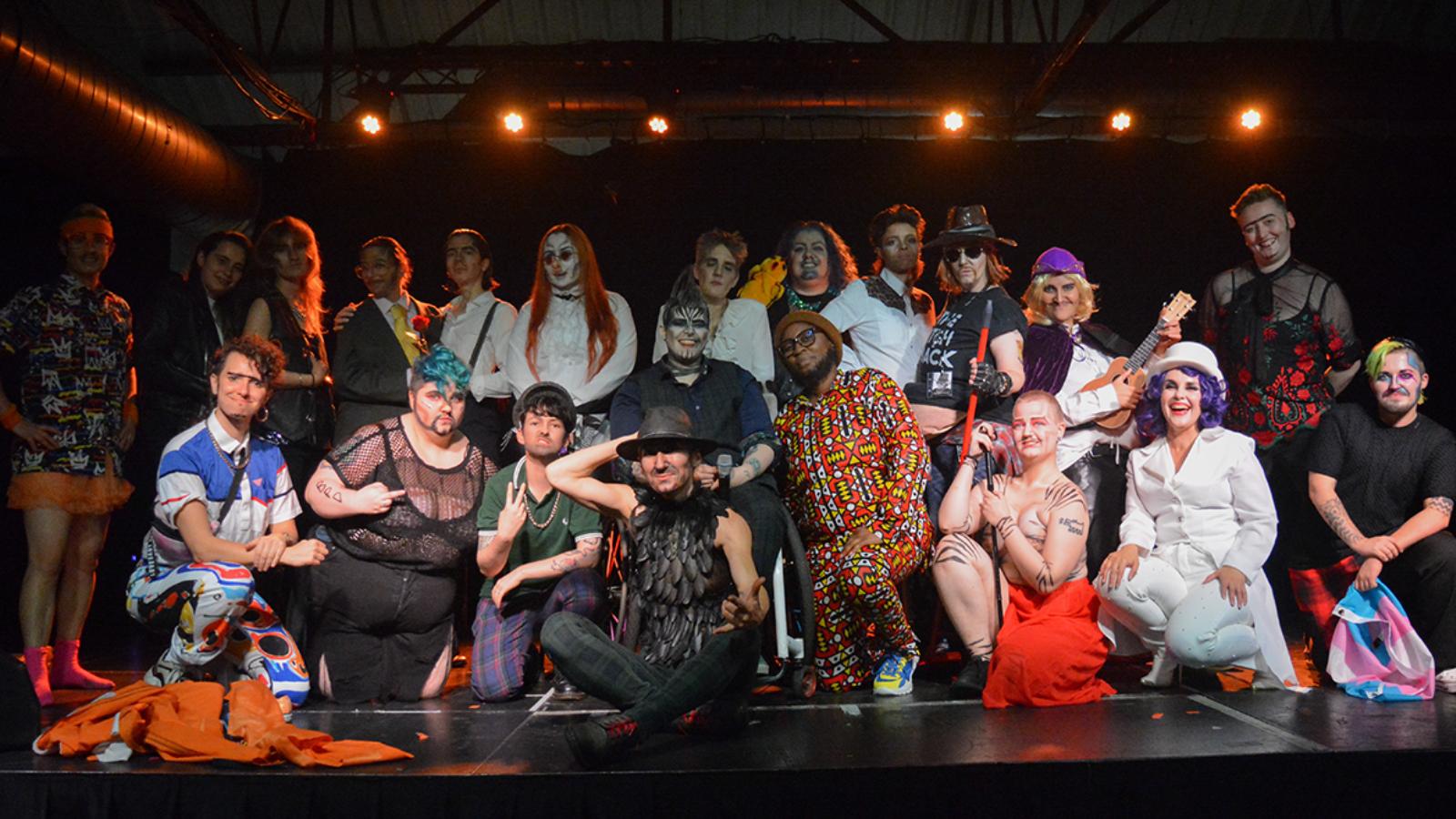 A group of drag kings stand on stage together