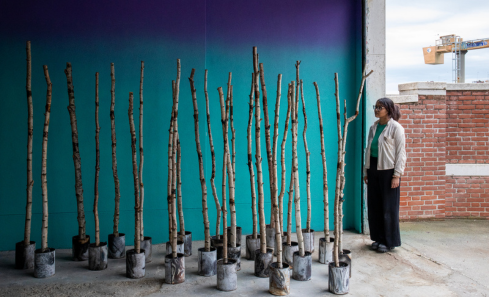 Alyesha Choudhury stands with birch trees from the Ravenscraig section of the exhibition in Venice