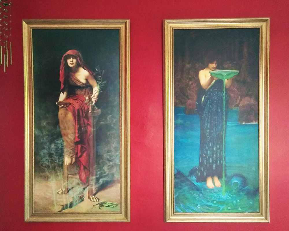 A photo of paintings hung in Ever Dundas' 'Writing Cave' which depict Circe and the Priestess of Delphi