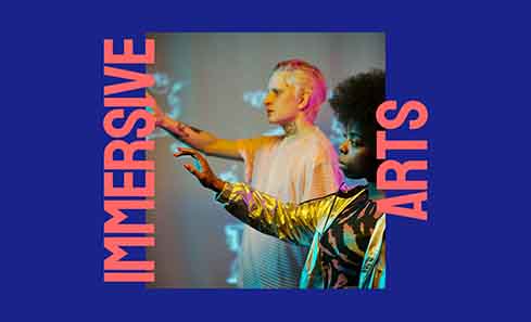 A blue rectangle and an image that shows two people reaching their arms up towards something unseen. The text reads 'Immersive Arts'